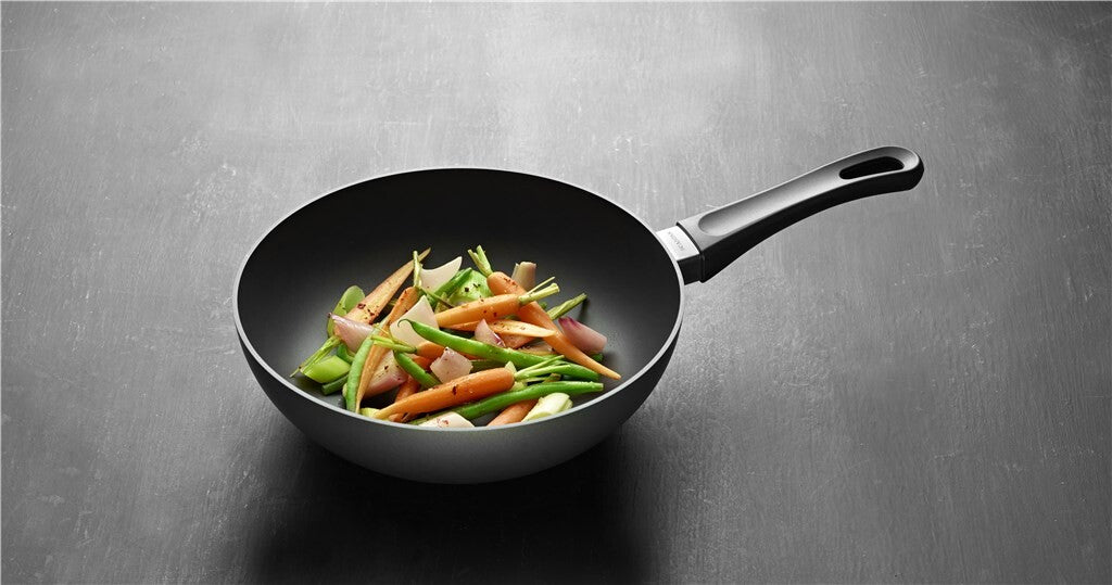 SCANPAN Classic stir-fry pan with vegetables on a grey background