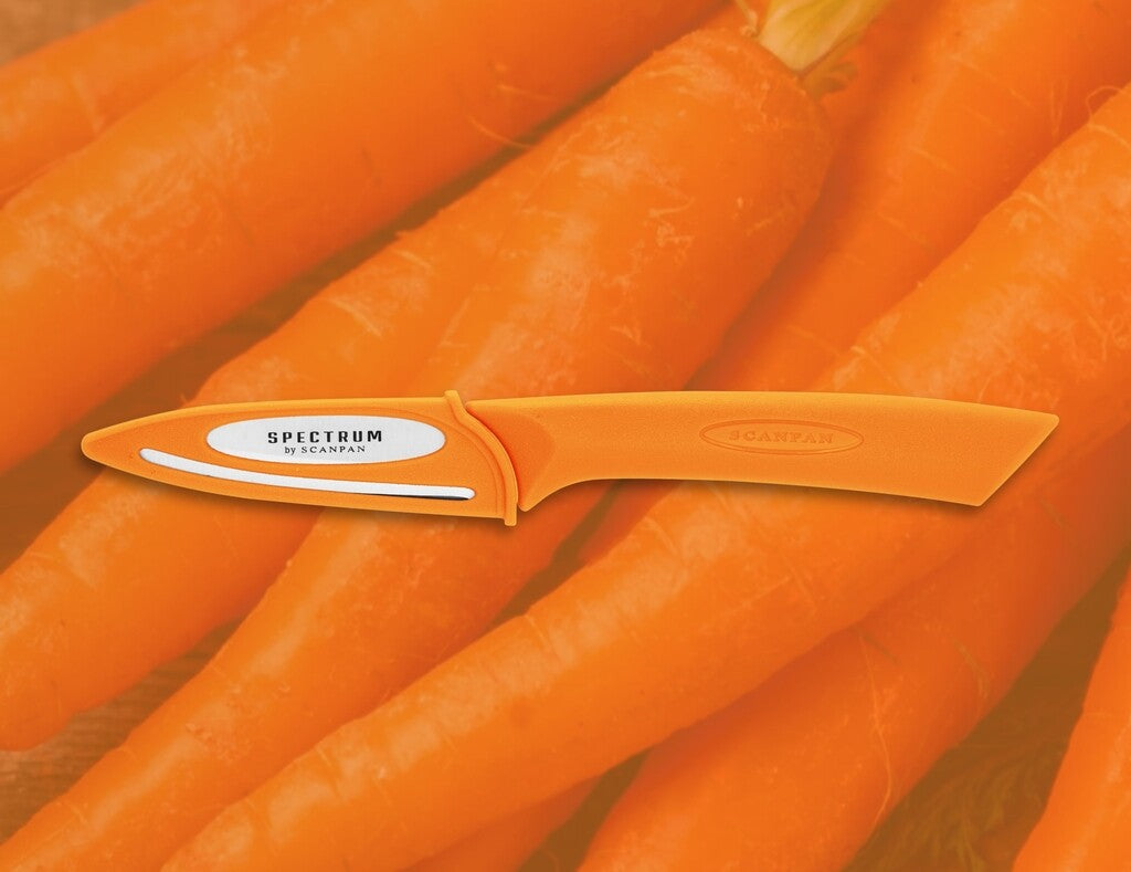 Spectrum paring knife 8 cm in Carrot Curl shown in use