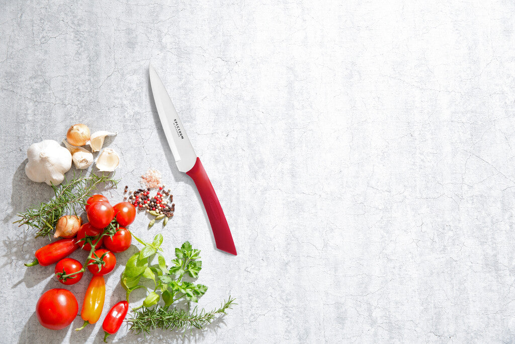 Spectrum vegetable knife in Red on a white background