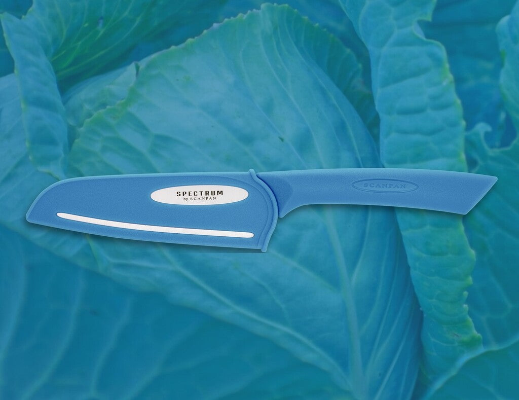 Spectrum santoku knife in Silver Lake Blue shown in use