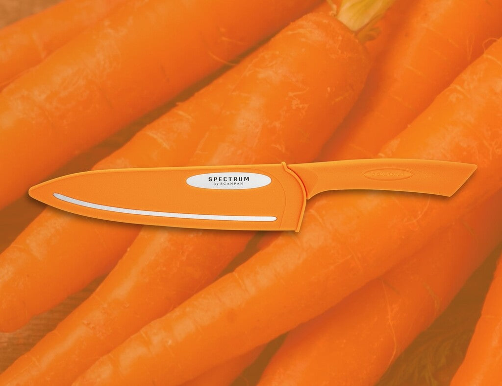 Spectrum chef's knife in Carrot Curl shown in use