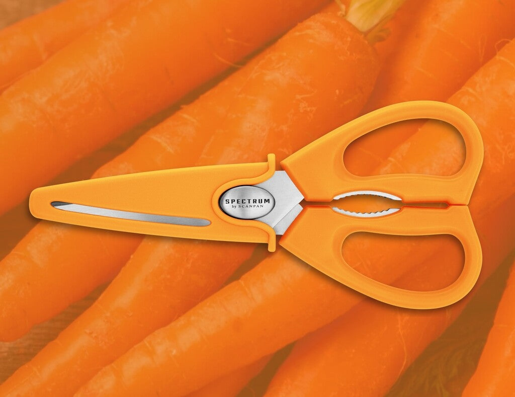 Spectrum kitchen scissors in Carrot Curl shown in use